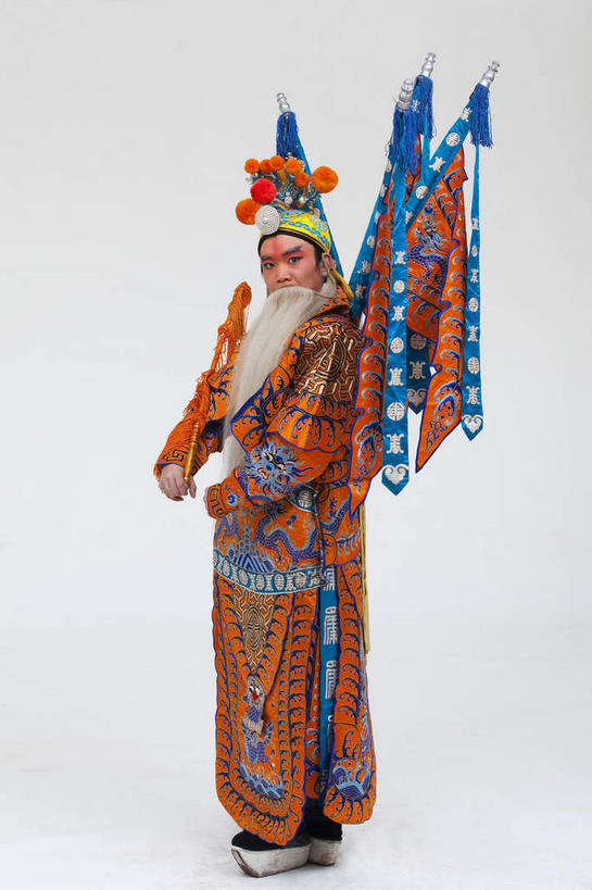 东方人,胡须,一个人,演员,站,竖图,室内,白天,白色背景,侧面,民族服装,化妆,竞争,旗帜,亚洲,仅一个男性,仅一个人,仅一个中年男性,一把,对抗,握,服装,冲突,头饰,注视,黄种人,破坏,文化,旗子,衣服,白色,彩妆,发夹,发饰,夹子,观察,看,站着,橙色,大衣,武器,战争,握着,摄影,服饰,影棚,观看,损坏,察看,攻击,威胁,衣着,穿着,对立,关注,矛盾,中国文化,摄影棚,兵器,防御,表演服,演出服,京剧,将军,戏曲,国粹,皮黄,敌对,挫败,斗争,抗拒,抗衡,杀伤,威慑,旌旗,旗号,衣饰,将领,道具服,危险,男人,男性,中年男性,亚洲人,胡子,络腮胡,站立,彩图,全身,影棚拍摄,传统服装,民俗服,拍摄,京剧服饰,国剧,京戏,平剧,中国戏曲,传统文化,关内侯,后将军,汉升,黄忠,舞台妆,京剧演员