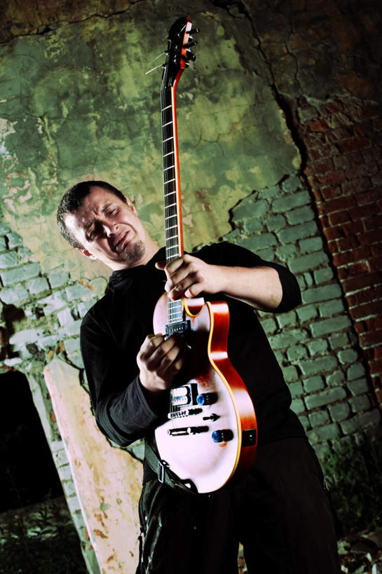 西方人,一个人,站,举,竖图,室外,白天,仰视,欧洲,欧洲人,仅一个男性,仅一个人,仅一个中年男性,一把,握,阴影,服装,光线,影子,墙,吉他,乐器,弦乐器,弹奏,拿,拿着,注视,休闲装,墙壁,墙面,衣服,观察,看,托,站着,休闲服,握着,服饰,观看,察看,关注,弹拨弦鸣乐器,男人,男性,中年男性,白种人,举起,举手,举着,向上举,向上伸,向上托,站立,半身,彩图,低角度拍摄,弹拨弦乐器