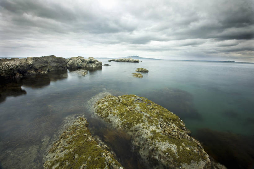 无人,横图,室外,白天,正面,旅游,度假,草地,草坪,海浪,海洋,石头,美景,沙滩,植物,新西兰,阴影,光线,沙子,石子,影子,海岸,景观,浪花,水平线,乌云,云,阴天,云朵,辽阔,海平线,沙地,云彩,娱乐,草,绿色,天空,阳光,自然,海水,天,享受,休闲,广阔,景色,放松,一望无际,昏暗,阴沉,自然风光,大洋洲,海景,奥克兰,纽西兰,长白云之乡,新西兰北岛,无边无际,一马平川,奥克兰区,奥克兰市,风帆之都,大海,风浪,海,海水的波动,海滩,近岸浪,石块,岩石,涌浪,彩图,水天相接,水天一线