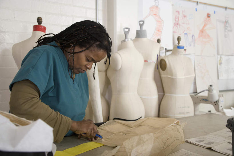 西方人,一个人,站,闭眼,横图,室内,白天,正面,桌面,桌子,欧洲,非洲,黑人,欧洲人,仅一个女性,仅一个人,握,花纹,服装,木制,布,人造模特,图案,图纸,墙,设计图,拿,布纹,拿着,休闲装,墙壁,墙面,衣服,白色,白板,木制品,低头,站着,仅一个中年女性,休闲,休闲服,握着,服饰,道具,布匹,记录板,记事板,模特道具,时装道具,女人,女性,中年女性,非洲人,设计,闭眼睛,闭着眼,闭着眼睛,站立,半身,彩图,纸样,服装纸样,服装样板,服装设计,服装模板,包布模特,服装立裁人台,人台,试衣模特,试衣人台