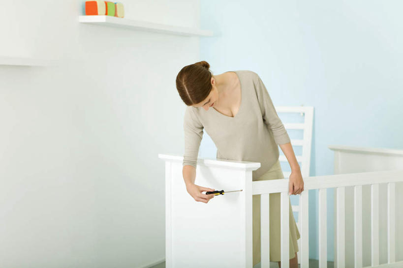 西方人,一个人,站,横图,室内,白天,正面,床,卧室,欧洲,欧洲人,仅一个年轻女性,仅一个女性,仅一个人,服装,工具,拿,拿着,注视,休闲装,维护,维修,修护,衣服,观察,看,站着,休闲,休闲服,服饰,观看,婴儿床,螺丝刀,起子,察看,关注,年轻女性,女人,女性,白种人,站立,半身,彩图,睡房,卧房