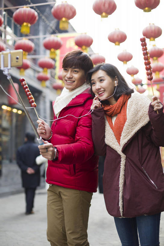 东方人,成年人,两个人,笑,微笑,露齿笑,竖图,室外,白天,正面,爱情,度假,快乐,幸福,技术,美景,城市风光,城市,胡同,街道,手机,照明,北京,中国,春节,亚洲,吊挂,握,悬挂,风俗,节日,庆祝,装饰,灯笼,纸灯笼,景观,冬天,美味,食品,耳塞,饮品,浪漫,音乐,挂,听,休闲装,娱乐,传统,饮食,食物,饮料,拍照,红色,耳麦,围巾,灯具,中国菜,甜食,看,站着,享受,休闲,温暖,温馨,景色,恩爱,放松,精神,亲密,握着,自拍,约会,恋人,摄影,生活方式,围脖,糖葫芦,保暖,华丽,照亮,点缀,和睦,享乐,仪式,御寒,照明设备,都市风光,可口,中国文化,典礼,市区,智能手机,视频会议,东亚,陪同,衬托,美观,雅致,雅观,无线电技术,元旦,制度,适口,陪伴,男人,男性,年轻男性,年轻女性,女人,女性,亚洲人,中国人,年轻人,情侣,休闲活动,说话,彩图,爱,欢乐,照相,伴侣,融洽,传统文化,冬衣,传统节日,伴随,自拍杆